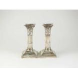 A pair of silver mounted candlesticks
