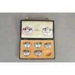 A cased set of Crown Staffordshire porcelain decanter labels and two enamelled examples