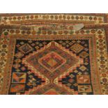 Kuba rug, North-East Caucasus, indigo field with three stepped medallions enclosed by ivory borders,