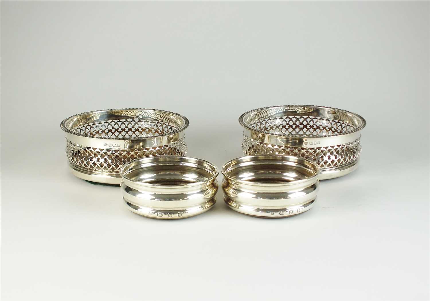 Two pairs of silver coasters