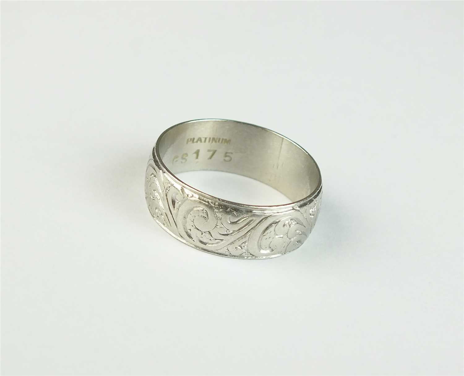 An engraved white metal band