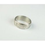 An engraved white metal band