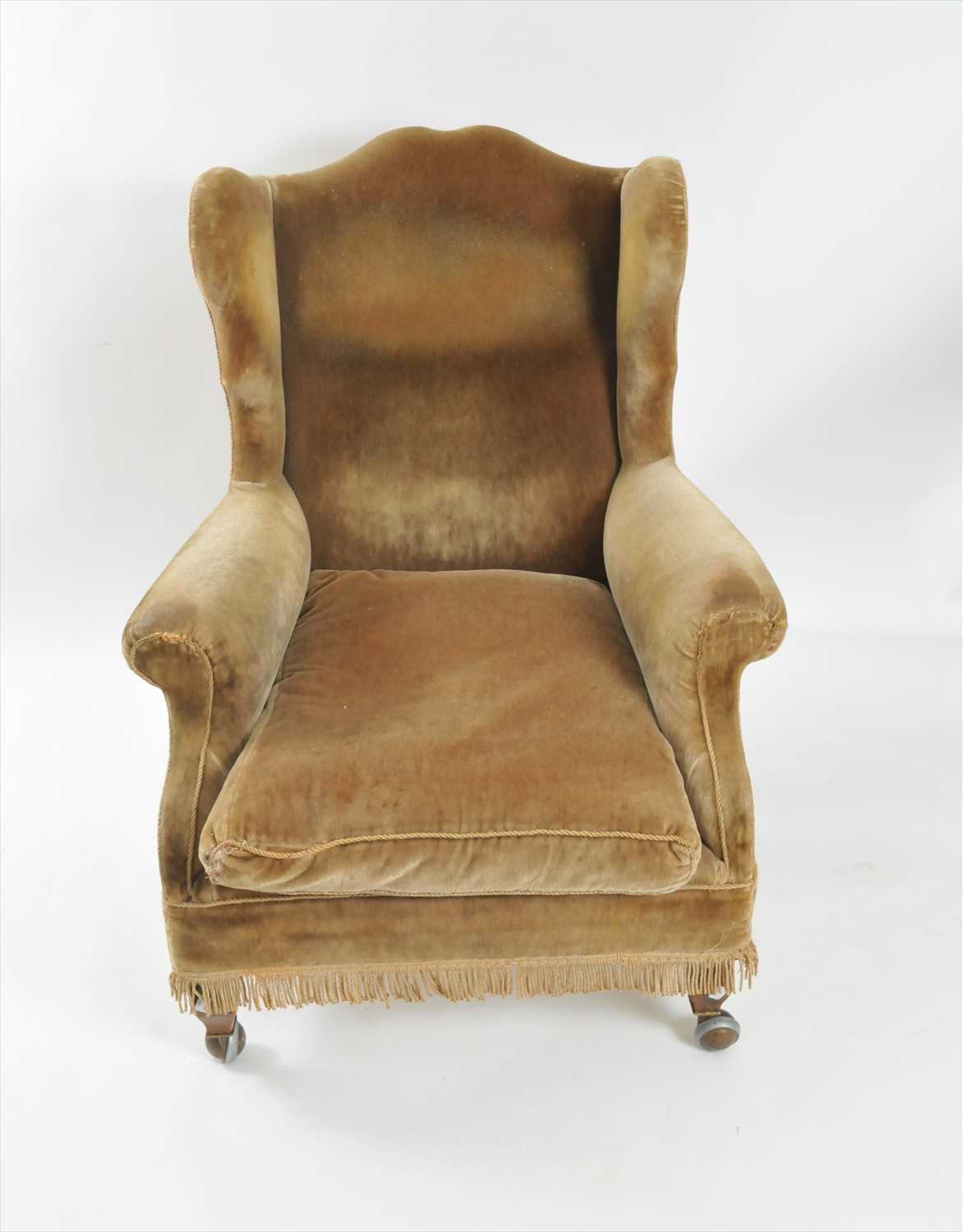A 19th century upholstered wing armchair