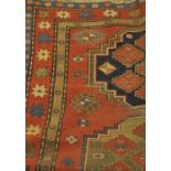 Kazak Rug, South Caucasus, the madder field with three medallions enclosed by stella motif