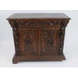 A late 19th century continental carved oak hall cupboard in the Flemish style