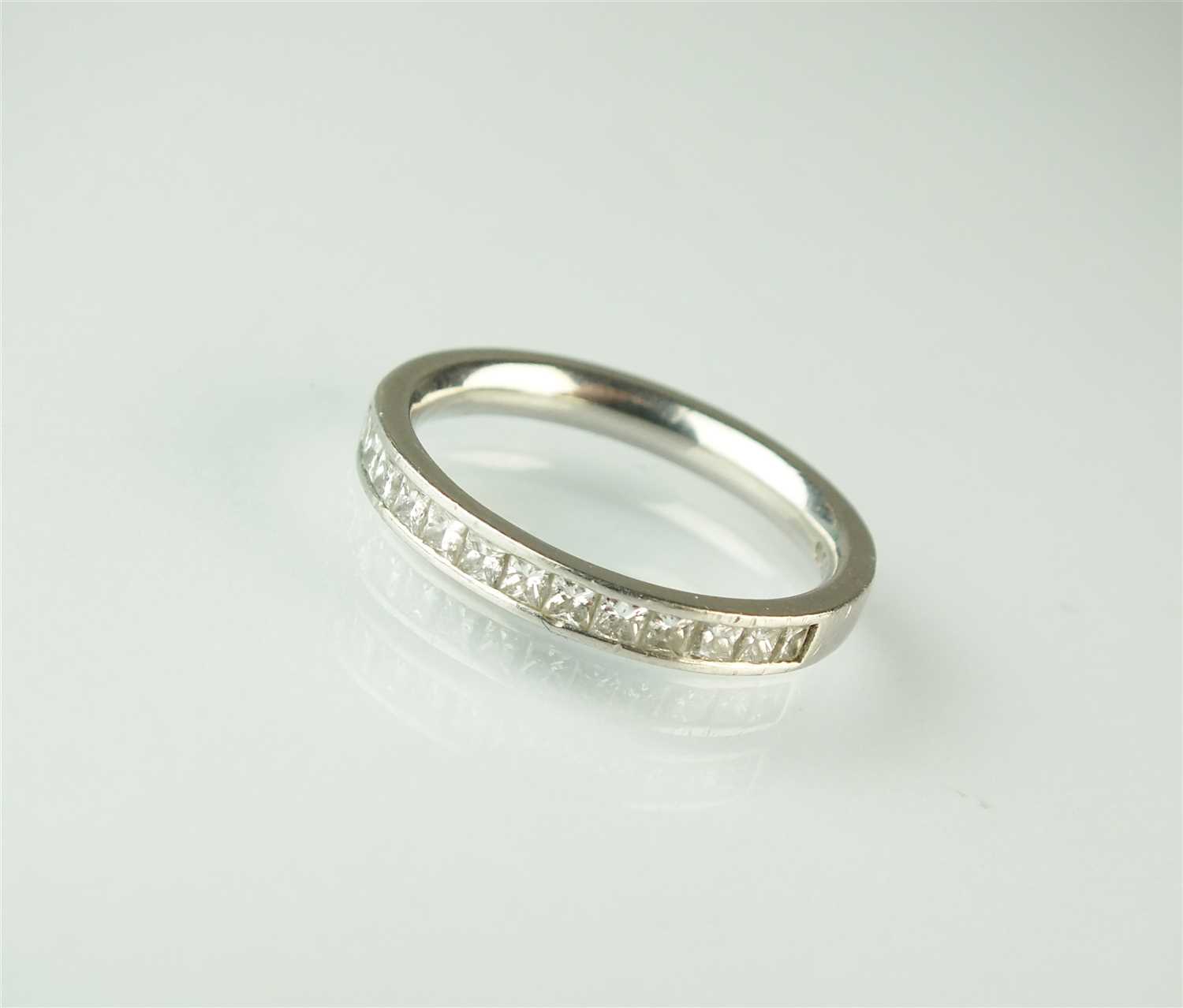 A platinum half hoop eternity ring