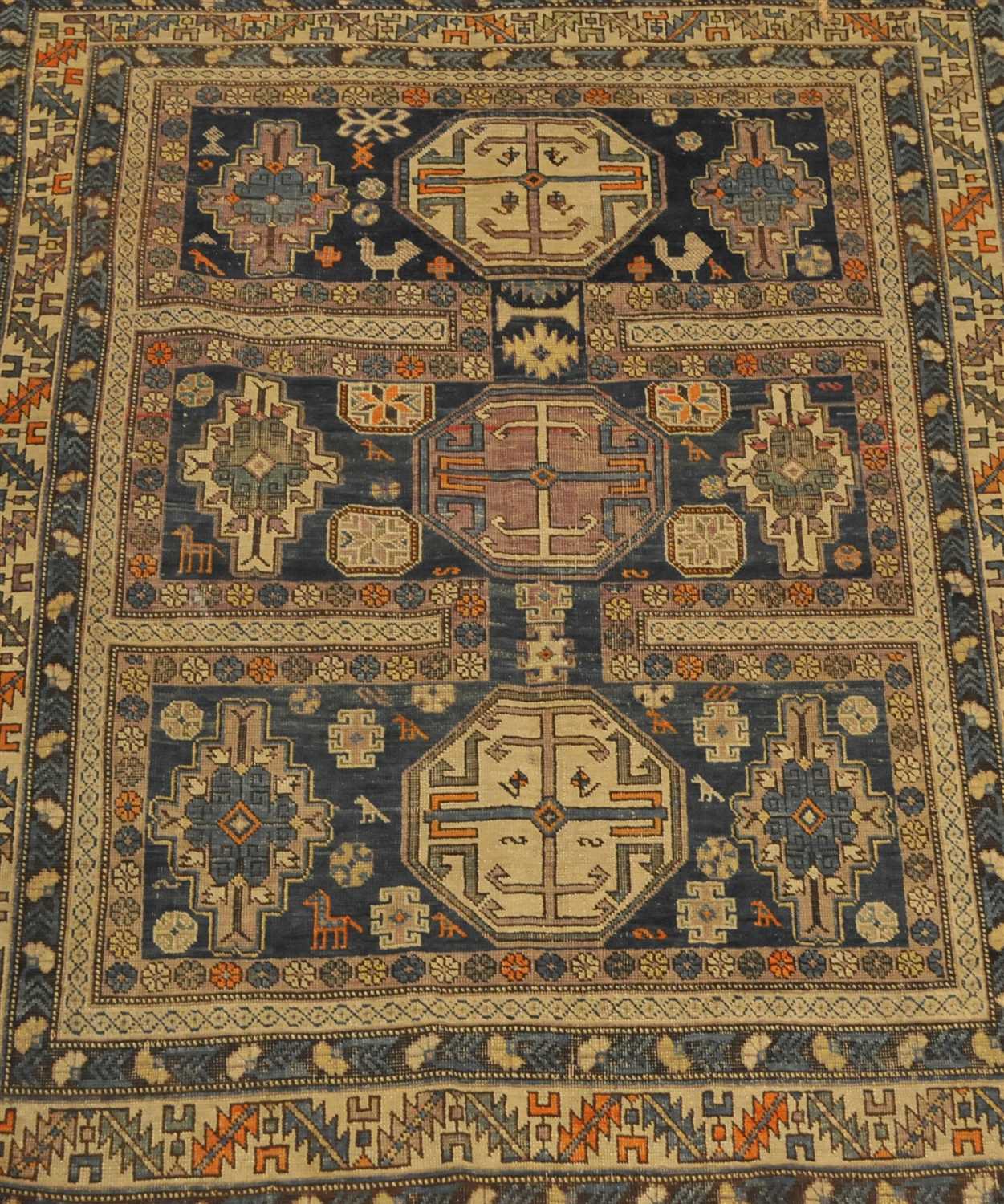 A Kuba rug, North-East Caucasus, the compartmentalised field with three octagons, enclosed by leaf