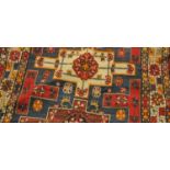A Kuba rug, North-East Caucasus, the indigo field with four cruciform medallions enclosed byharshang