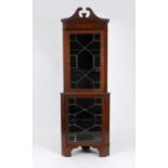 An Edwardian mahogany two sectional corner cupboard