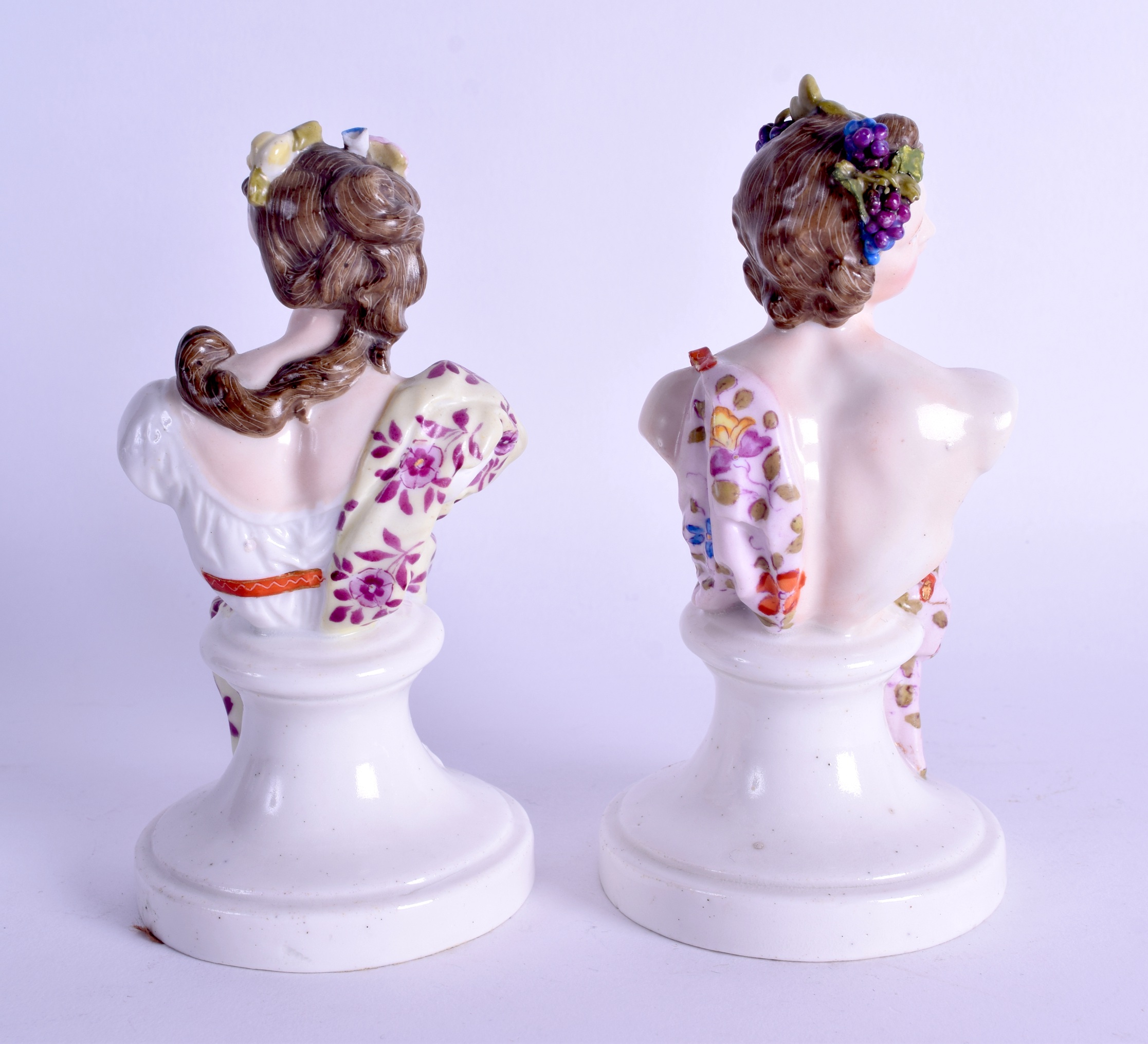 A PAIR OF 19TH CENTURY GERMAN PORCELAIN FIGURAL BUSTS painted with foliage and vines. 15 cm high. - Image 2 of 3