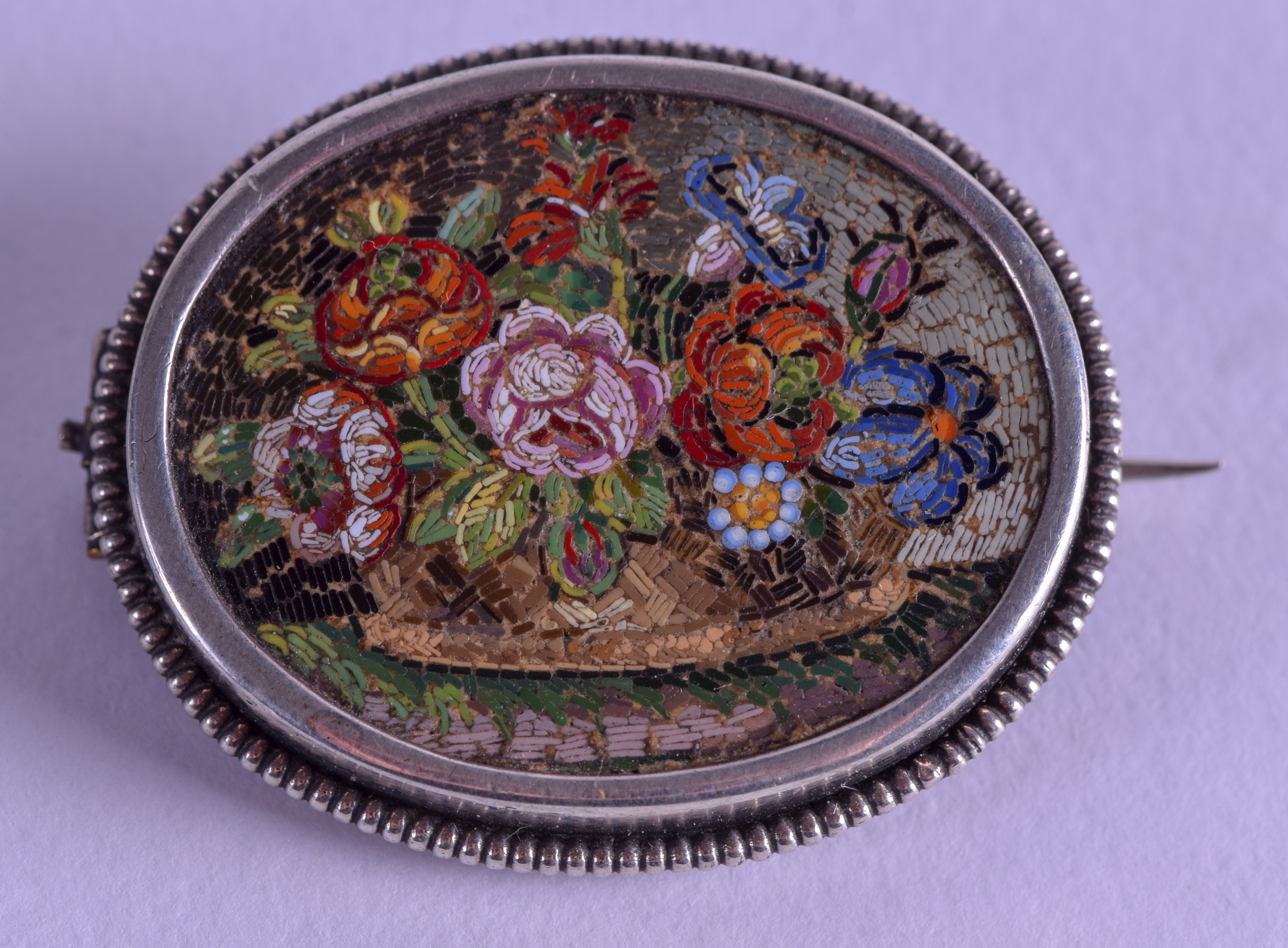 A GOOD 19TH CENTURY ITALIAN MICRO MOSAIC SILVER BROOCH decorated with flowers. 3.5 cm x 3 cm.