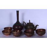 A SET OF EIGHT ISLAMIC COPPER BOWLS, together with a tea pot and a vase engraved with flowers.