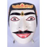A BALINESE CARVED WOODEN DALEM KING RAJA DANCE MASK, formed as the romantic hero. 18 cm x 14 cm.