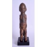 AN EARLY 20TH CENTURY AFRICAN CARVED HARDWOOD TRIBAL FERTILITY FIGURE modelled upon a square base.