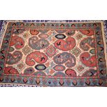 A 20TH CENTURY KASHMIR HAND MADE CHAIN STITCH RUG, decorated with motifs. 146 cm x 92 cm.