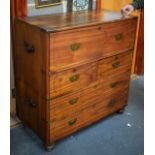 AN ANTIQUE WOODEN CAMPAIGN CHEST, in two parts with brass corners and iron carrying handles, on