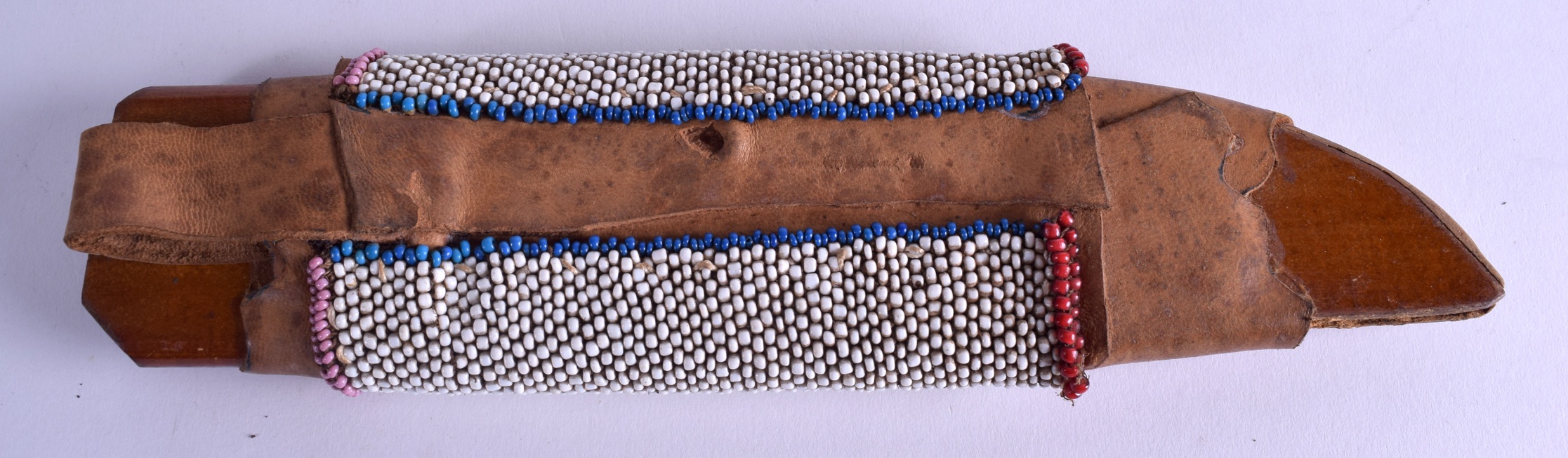 A NATIVE AMERICAN BEAD WORK KNIFE SCABBARD decorated with coloured triangular motifs. 28 cm long. - Image 2 of 2