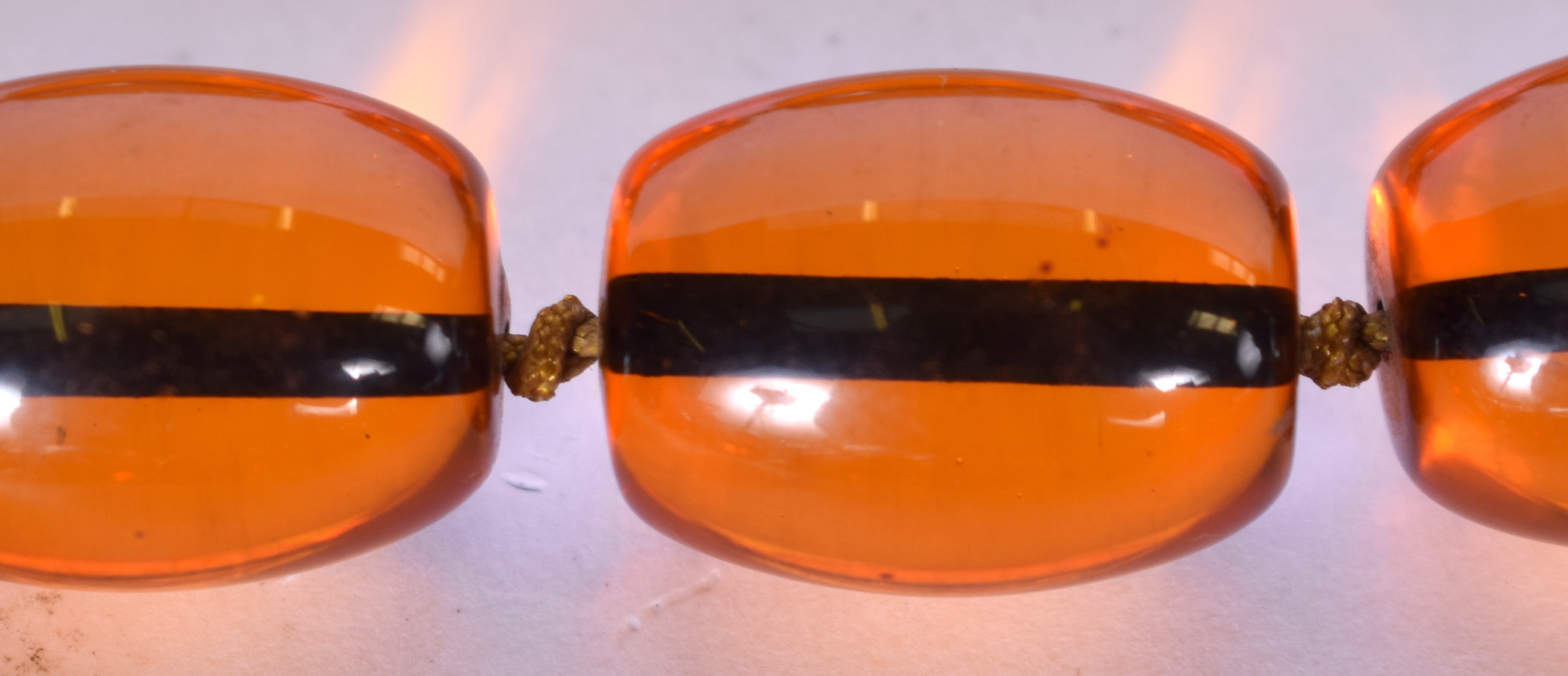 A LARGE AMBER TYPE NECKLACE, together with a similar. Largest bead 2.1 cm and total length 86 cm - Image 2 of 3