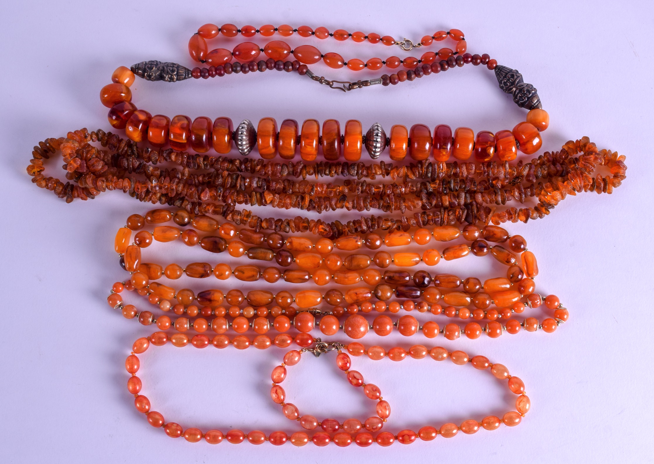 A COLLECTION OF VINTAGE AMBER NECKLACES in various forms and sizes. (qty)