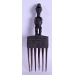AN UNUSUAL AFRICAN CARVED TRIBAL COMB with figural terminal and engraved zig zags to body. 28 cm x 9