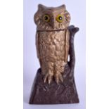 A LATE VICTORIAN CAST IRON OWL MONEY BOX modelled with amber coloured eyes. 20 cm high.