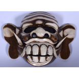 A BALINESE CARVED WOODEN CULULUK WITCH DANCE MONKEY MASK, formed with moveable jaw. 30 cm wide.