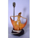 AN ART DECO PLASTER FIGURAL LAMP, formed as a standing female in a flowing sunburst orange dress.