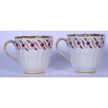 A PAIR OF 19TH CENTURY SHANKERED WORCESTER PORCELAIN COFFEE CUPS, decorated with gilt and puce