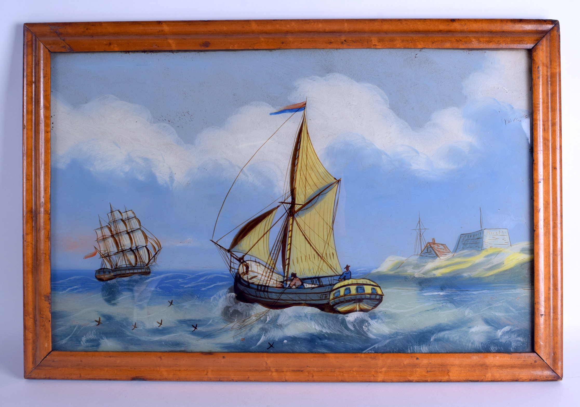 A VICTORIAN REVERSE PAINTED GLASS MARITIME PANEL depicting a boat in full sail leaving a port. Image