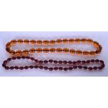 A LARGE AMBER TYPE NECKLACE, together with a similar. Largest bead 2.1 cm and total length 86 cm