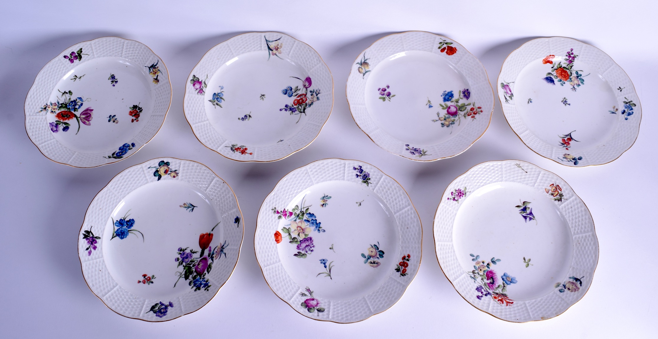 A SET OF SEVEN 18TH CENTURY OUD LOOSDRECHT PORCELAIN PLATES painted with floral sprays in the