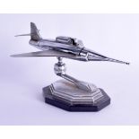 A STYLISH 1950S CHROME AVIATION TABLE LIGHTER modelled upon a Bakelite base. Plane 25 cm x 18 cm.