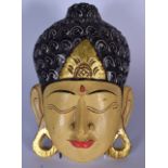 A BALINESE CARVED WOODEN MASK OF YOUNG BUDDHA, formed with peaceful expression. 31.5 cm x 20.5 cm.