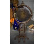 A LARGE IRON GONG 7 STAND ATTRIBUTED TO CHRISTOPHER DRESSER (1834-1904), formed with scrolling