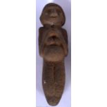 A LARGE EASTERN CARVED STONE FIGURE, modelled with hands clasped in front of chest. 39 cm long.