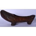 AN UNUSUAL EARLY 20TH CENTURY WOODEN CARVED TRIBAL SHOE, with lattice like decoration. 33 cm wide.