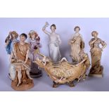 AN AUSTRIAN PORCELAIN TABLE CENTREPIECE, together with six figurines of varying style. Largest 37