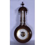 AN EARLY 20TH CENTURY WOODEN BAROMETER, with turned finial and foliate type carved detail. 69 cm