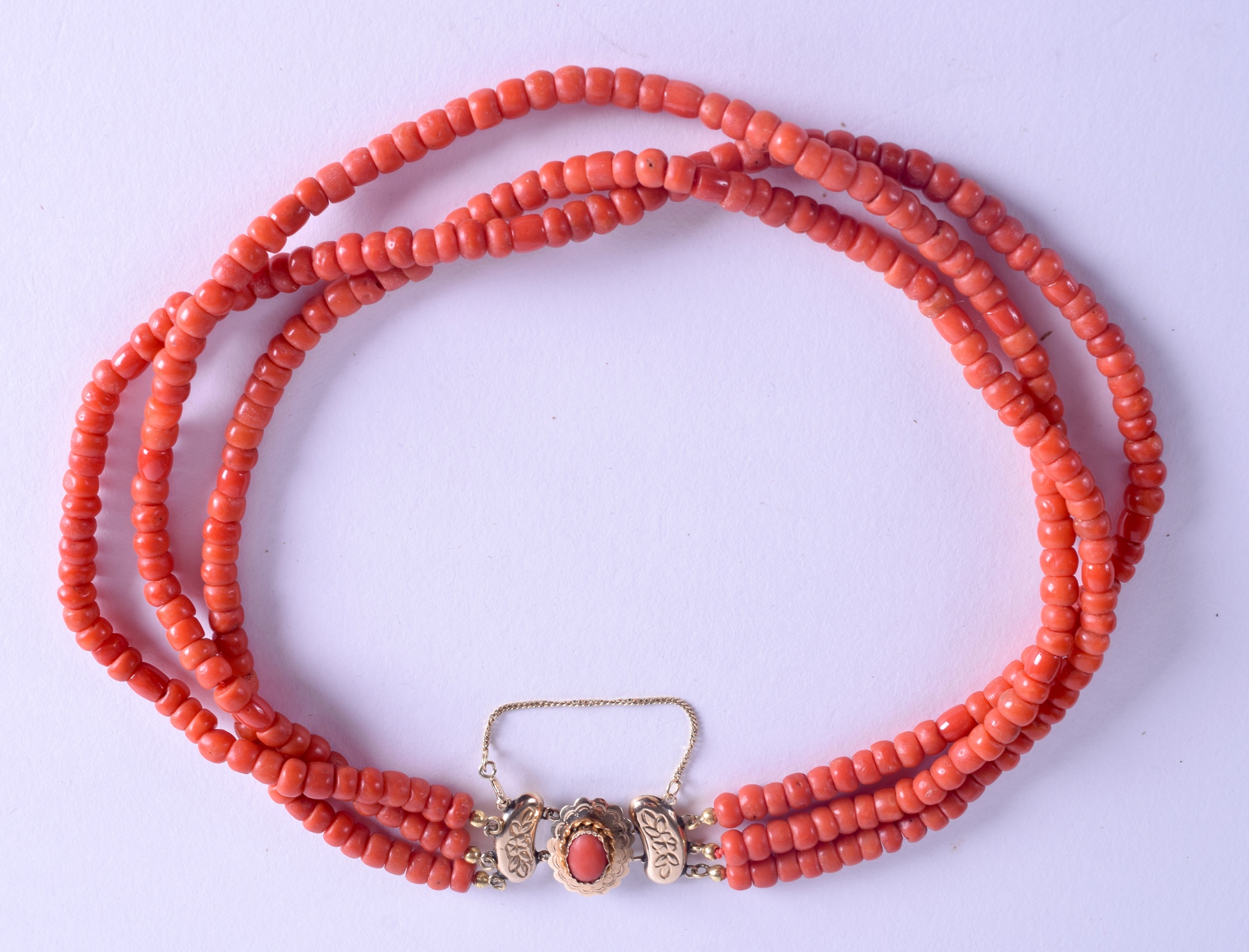 AN 18CT GOLD MOUNTED CORAL NECKLACE. 700 grams. Each strand 40 cm long, each bead 0.3 mm wide.