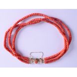 AN 18CT GOLD MOUNTED CORAL NECKLACE. 700 grams. Each strand 40 cm long, each bead 0.3 mm wide.