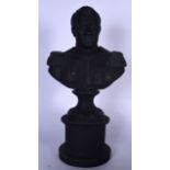 AN EARLY 20TH CENTURY BLACK BASALT POTTERY BUST OF NAPOLEON, formed upon a circular plinth. 50 cm