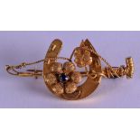 AN EDWARDIAN GOLD AND SAPPHIRE HORSE SHOE BROOCH. 7.1 grams. 5.25 cm wide.