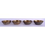 A SET OF FOUR 19TH CENTURY MIDDLE EASTERN SILVER INLAID BRASS BOWLS