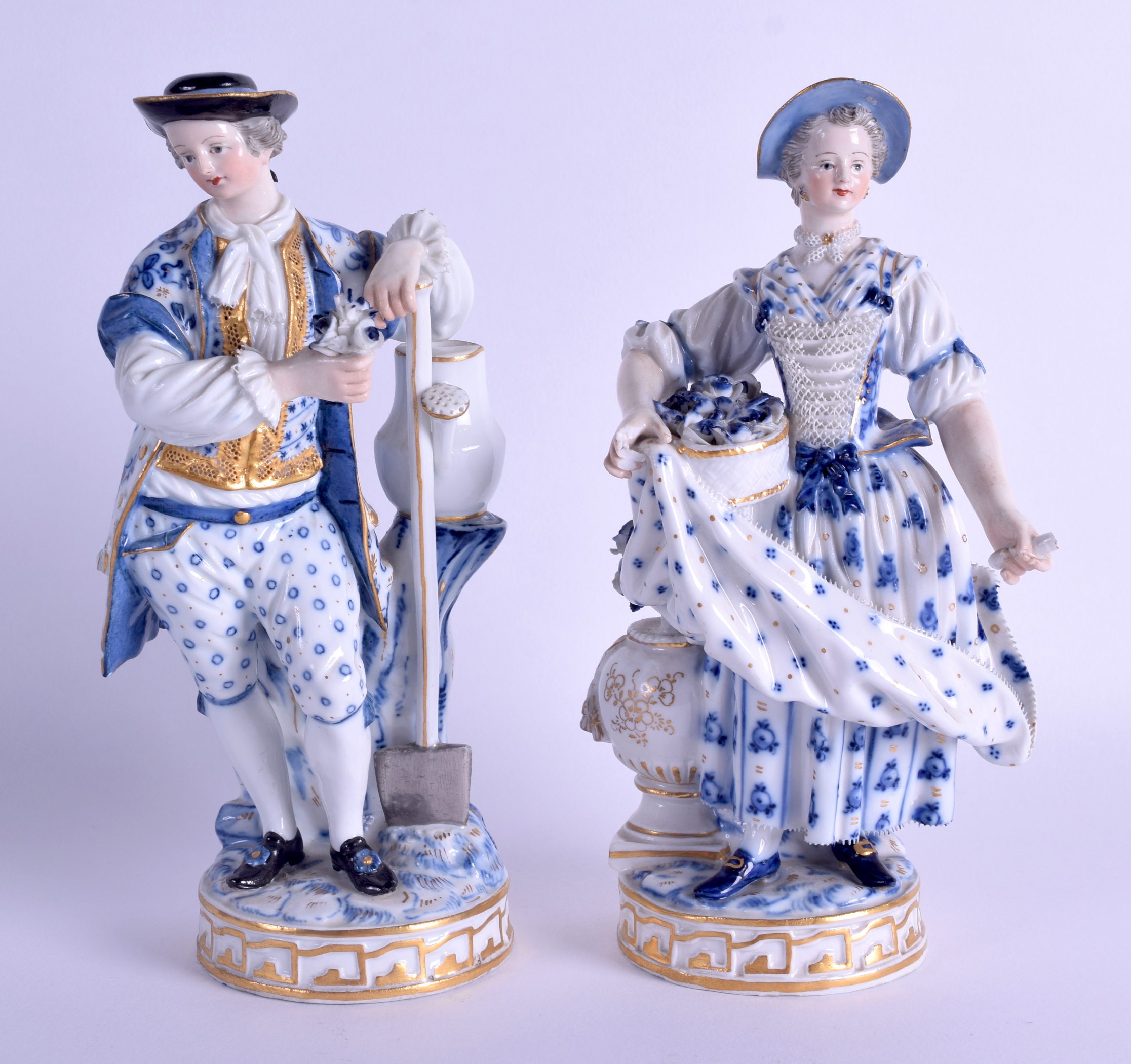 A PAIR OF 19TH CENTURY MEISSEN PORCELAIN FIGURES OF GARDENERS painted with blue flowers. 19 cm