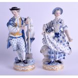 A PAIR OF 19TH CENTURY MEISSEN PORCELAIN FIGURES OF GARDENERS painted with blue flowers. 19 cm