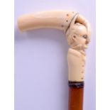 A RARE 19TH CENTURY CARVED IVORY HANDLED WALKING CANE modelled as a hand squeezing the nose of a