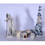 A PARIAN FIGURINE OF A MALE HOLDING A SPEAR BESIDE A FEMALE, together with a candlestick figure,