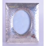 AN ARTS AND CRAFTS CONTINENTAL JEWELLED PHOTOGRAPH FRAME decorated with three garnets. 13 cm x 16