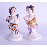 A PAIR OF 19TH CENTURY GERMAN PORCELAIN FIGURAL BUSTS painted with foliage and vines. 15 cm high.