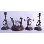 AN UNUSUAL EARLY 20TH CENTURY GERMAN BRONZE GNOME DESK SET modelled at work upon naturalistic bases.